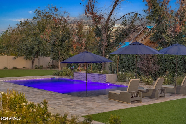 view of pool featuring a patio area and a lawn