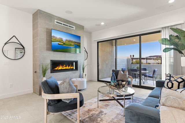 tiled living room with a tile fireplace