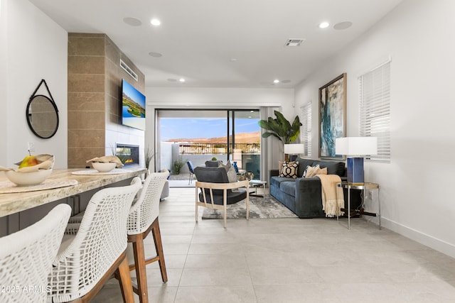 tiled dining space featuring a tiled fireplace