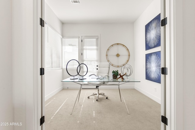 unfurnished office featuring light colored carpet