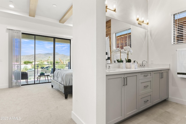 bathroom with vanity, a mountain view, and beam ceiling