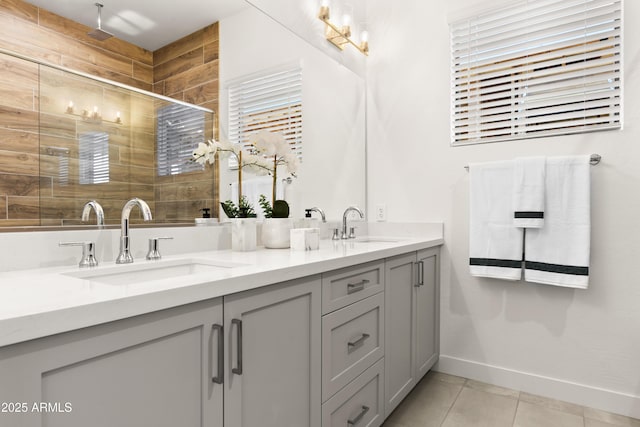 bathroom with tile patterned flooring, vanity, and walk in shower