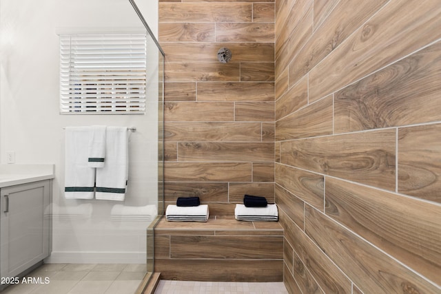 bathroom featuring vanity, tile patterned flooring, and a shower