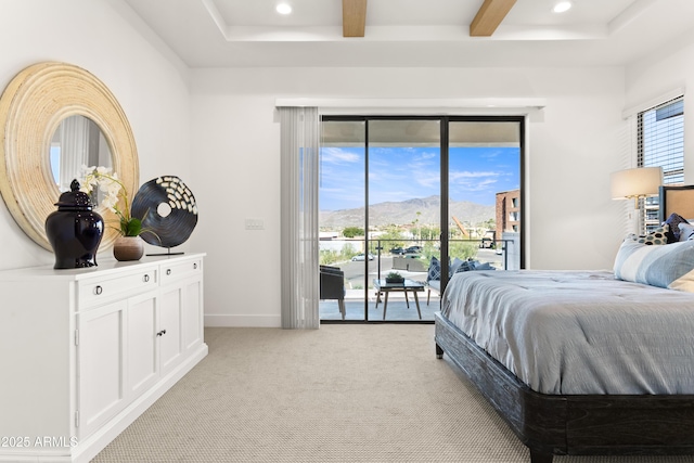 carpeted bedroom with a mountain view, access to outside, and beamed ceiling