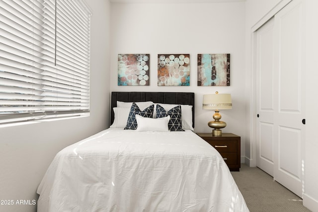 carpeted bedroom with a closet