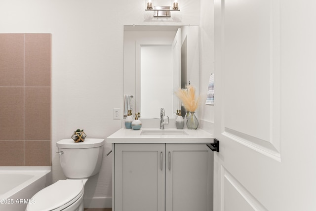 bathroom with vanity, a washtub, and toilet