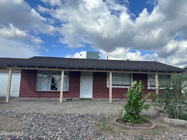 single story home featuring a garage and covered porch