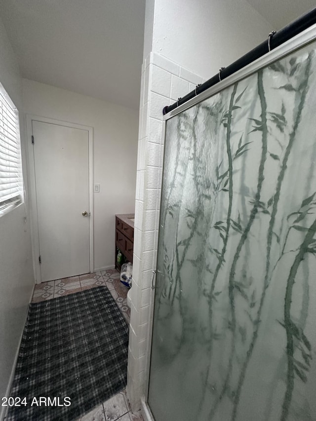 4232 W Citrus Way, Phoenix, AZ 85019 - bathroom with a stall shower, tile patterned flooring, and vanity