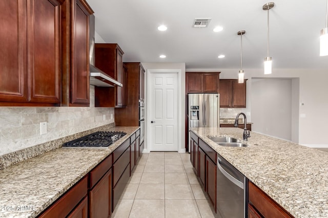 kitchen with appliances with stainless steel finishes, sink, backsplash, hanging light fixtures, and light stone countertops