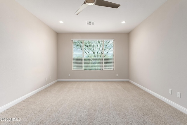 empty room featuring light carpet and ceiling fan