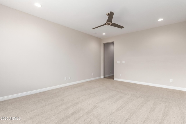 unfurnished room with ceiling fan and light colored carpet