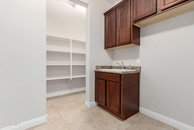 interior space with sink and light tile patterned floors