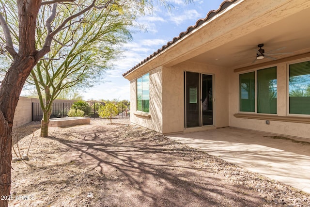 exterior space featuring ceiling fan