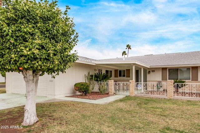 ranch-style home with a fenced front yard, covered porch, a front yard, a garage, and driveway