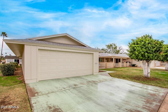 single story home featuring an attached garage, concrete driveway, and a front yard