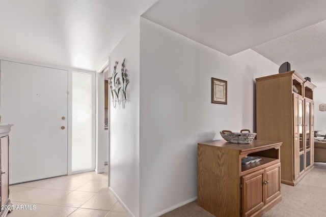 interior space with light tile patterned floors and baseboards