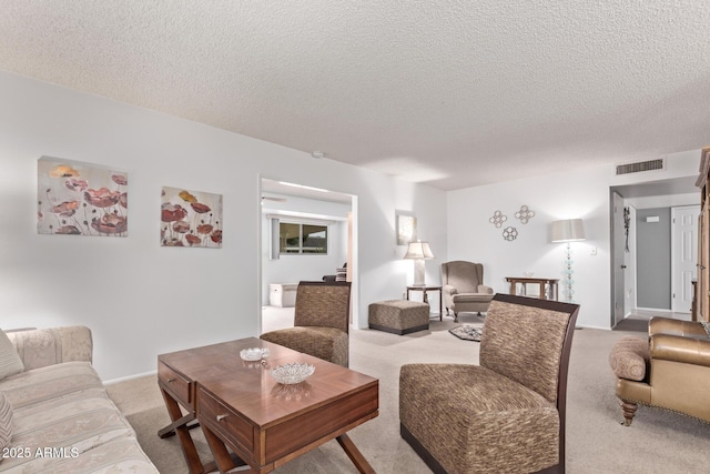 carpeted living area featuring visible vents and a textured ceiling