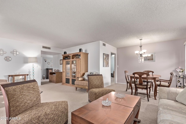 living area featuring light colored carpet, visible vents, and a notable chandelier