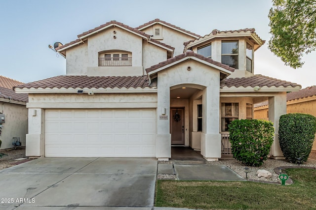 6846 S 26th Pl, Phoenix, AZ 85042 - mediterranean / spanish home featuring driveway, a garage, a tiled roof, and stucco siding