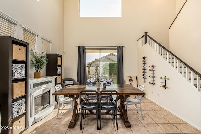 6846 S 26th Pl, Phoenix, AZ 85042 - dining area with a high ceiling, light tile patterned floors, and stairs