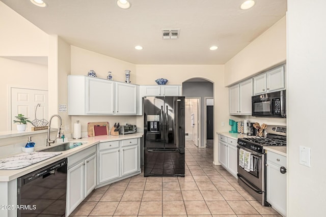 6846 S 26th Pl, Phoenix, AZ 85042 - kitchen with black appliances, arched walkways, light countertops, recessed lighting, and light tile patterned flooring