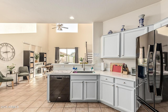 6846 S 26th Pl, Phoenix, AZ 85042 - kitchen with fridge with ice dispenser, black dishwasher, light countertops, a peninsula, and light tile patterned floors