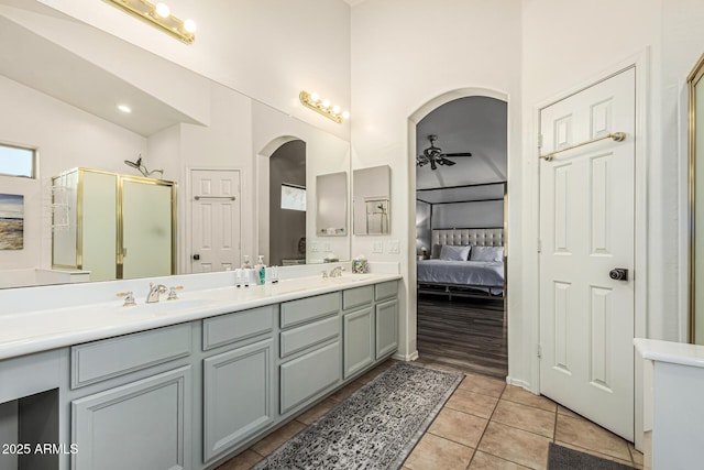 6846 S 26th Pl, Phoenix, AZ 85042 - ensuite bathroom with double vanity, a shower stall, a ceiling fan, tile patterned flooring, and high vaulted ceiling