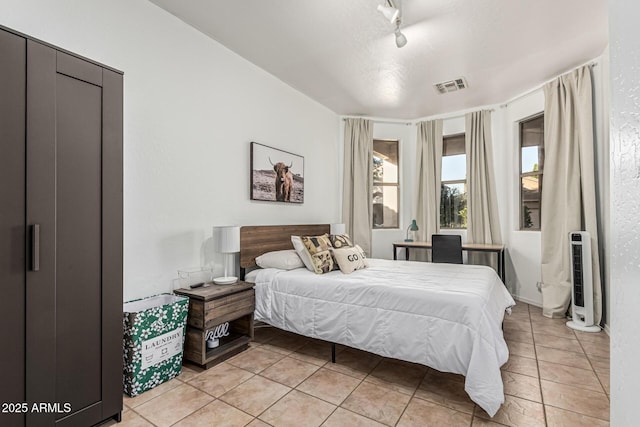 6846 S 26th Pl, Phoenix, AZ 85042 - bedroom featuring light tile patterned floors and track lighting