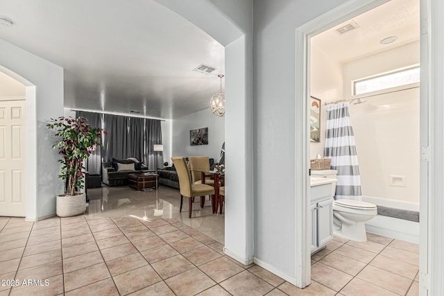6846 S 26th Pl, Phoenix, AZ 85042 - corridor with light tile patterned floors and arched walkways