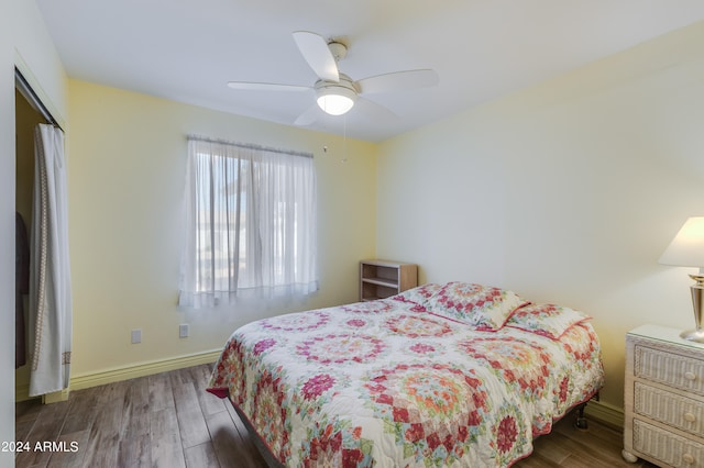 bedroom featuring a closet, ceiling fan, and dark wood-type flooring