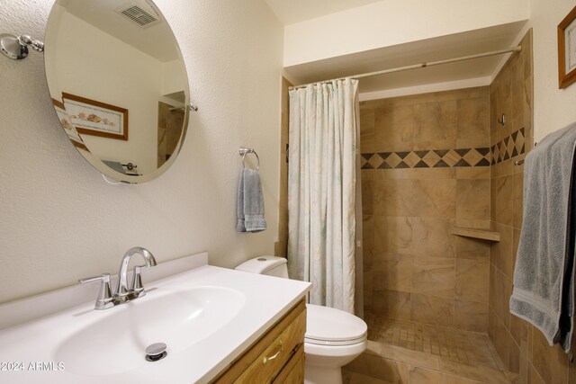 bathroom featuring tile patterned floors, a shower with curtain, vanity, and toilet