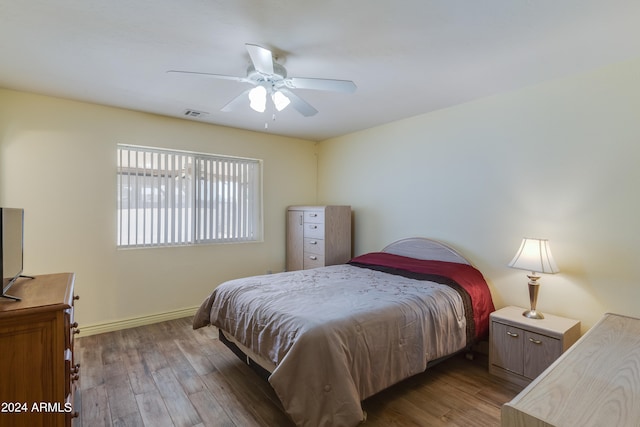 bedroom featuring dark hardwood / wood-style floors and ceiling fan