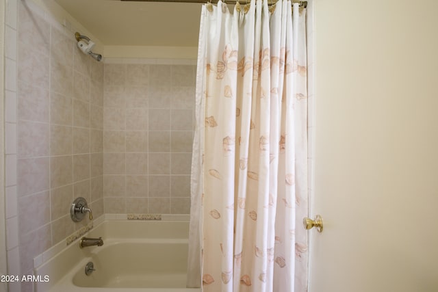 bathroom featuring shower / tub combo with curtain