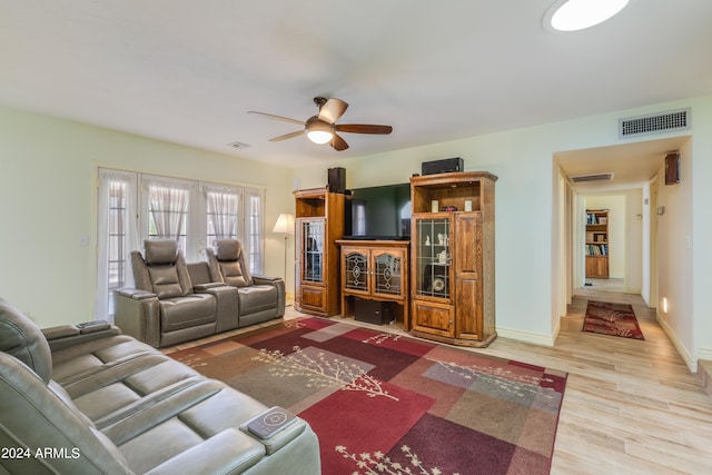 living room with ceiling fan, light hardwood / wood-style flooring, and french doors