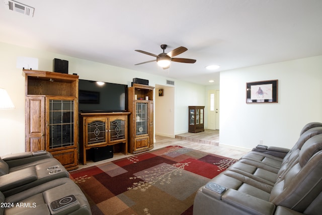 living room featuring hardwood / wood-style floors and ceiling fan