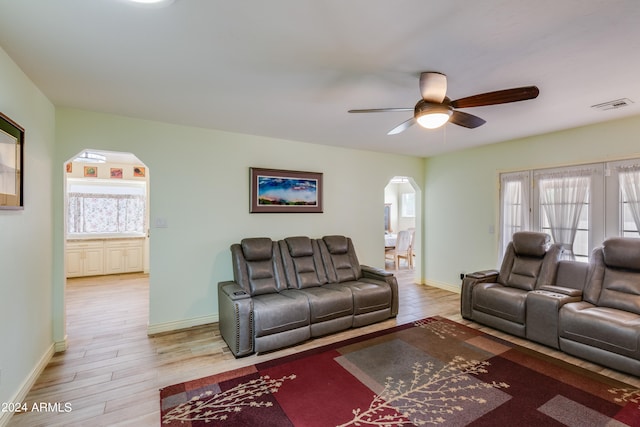 living room with light hardwood / wood-style floors, plenty of natural light, and ceiling fan