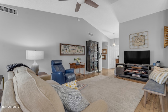 living room featuring ceiling fan, lofted ceiling, and light hardwood / wood-style floors