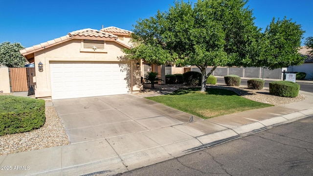 2615 N 123rd Dr, Avondale, AZ 85392 - view of front of home with a tile roof, stucco siding, an attached garage, driveway, and a gate