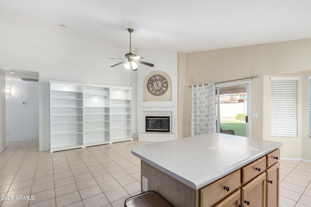 2615 N 123rd Dr, Avondale, AZ 85392 - kitchen featuring ceiling fan, light tile patterned floors, a glass covered fireplace, open floor plan, and lofted ceiling
