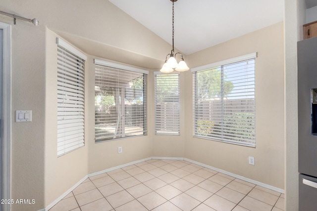 2615 N 123rd Dr, Avondale, AZ 85392 - unfurnished dining area featuring lofted ceiling, light tile patterned floors, a chandelier, and baseboards