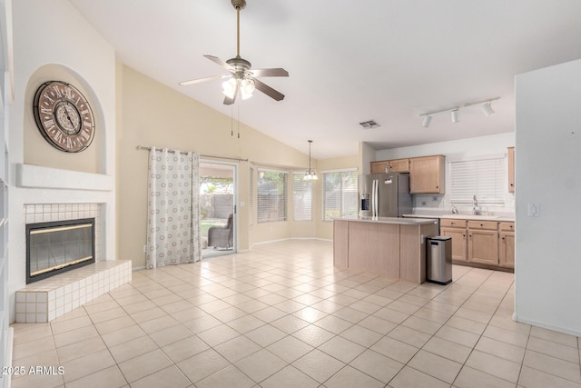 2615 N 123rd Dr, Avondale, AZ 85392 - kitchen featuring stainless steel refrigerator with ice dispenser, open floor plan, ceiling fan, light countertops, and vaulted ceiling