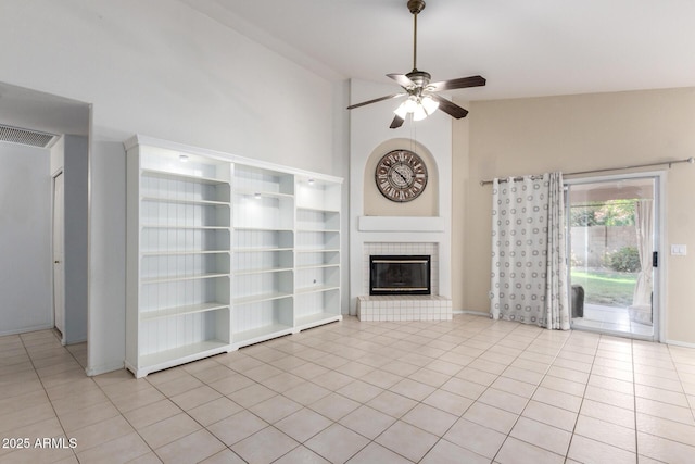 2615 N 123rd Dr, Avondale, AZ 85392 - unfurnished living room featuring light tile patterned floors, ceiling fan, a tiled fireplace, and high vaulted ceiling