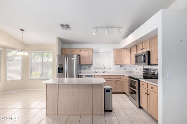 2615 N 123rd Dr, Avondale, AZ 85392 - kitchen featuring appliances with stainless steel finishes, light countertops, a chandelier, light tile patterned floors, and a sink