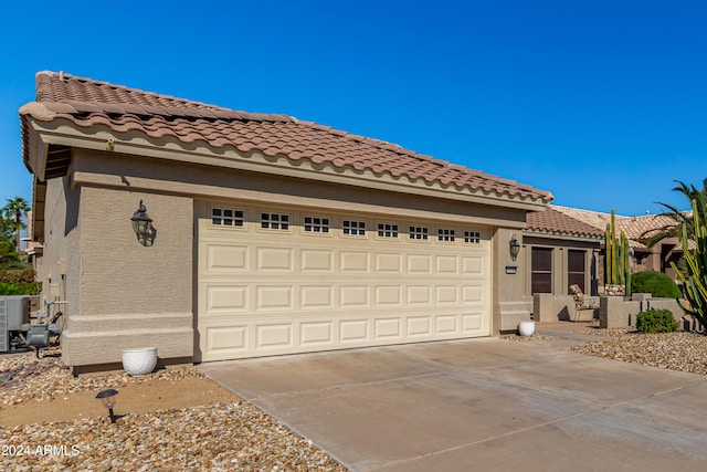 mediterranean / spanish house with a garage