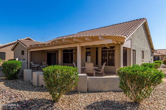 14766 W Piccadilly Rd, Goodyear, AZ 85395 - rear view of house featuring a patio, stucco siding, and a tile roof