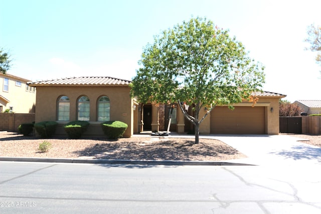 20243 E Poco Calle, Queen Creek, AZ 85142 - mediterranean / spanish home featuring driveway, a tile roof, fence, an attached garage, and stucco siding