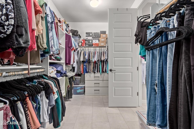 spacious closet with light tile patterned floors