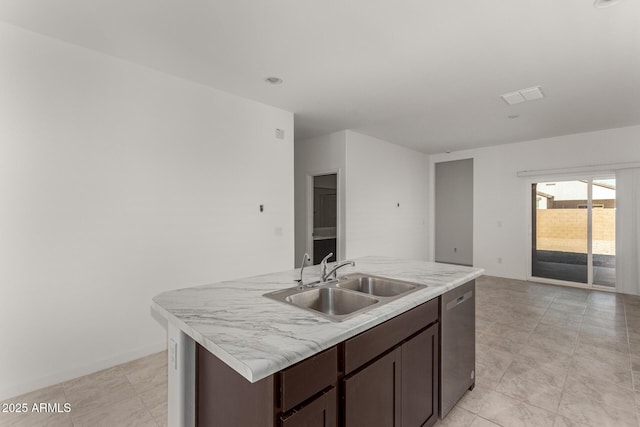 kitchen featuring sink, an island with sink, stainless steel dishwasher, and dark brown cabinets