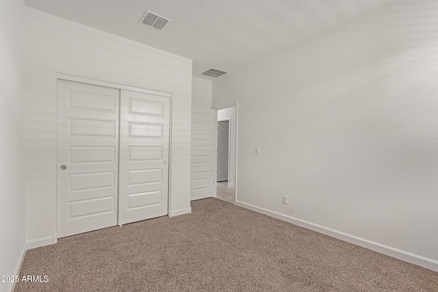 unfurnished bedroom with a closet and carpet flooring