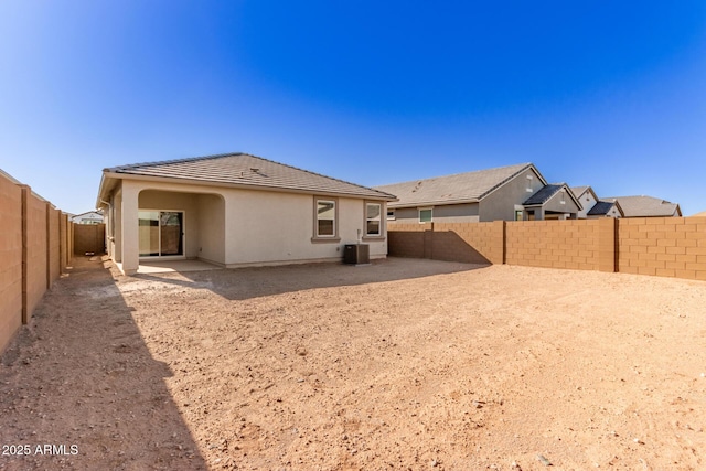 rear view of house featuring central AC unit and a patio